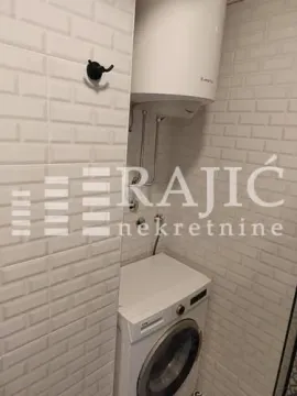 Bathroom with white tiles, washing machine and boiler. - image 12