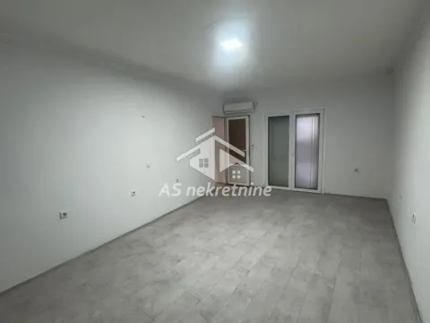 Empty room with white walls, tiled floor, and access to a terrace. - image 7