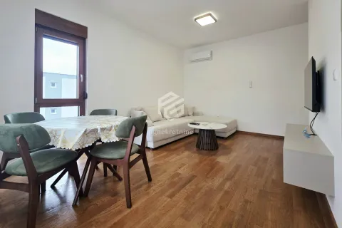 Living room with a sofa, dining table, and television. - image 15