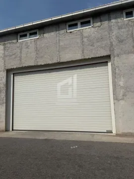 View of the garage door and the building facade. - image 9