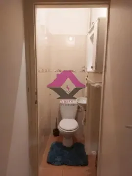 Small bathroom with a toilet and sink. - image 14