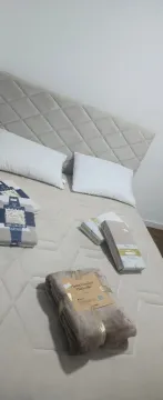 Bedroom with a double bed and pillows. - image 4