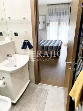 View from the bathroom towards the bedroom. - image 7