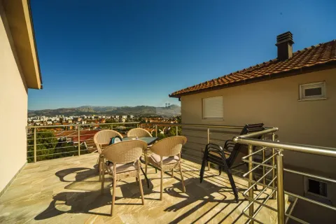 Spacious terrace with outdoor seating and city views. - image 9