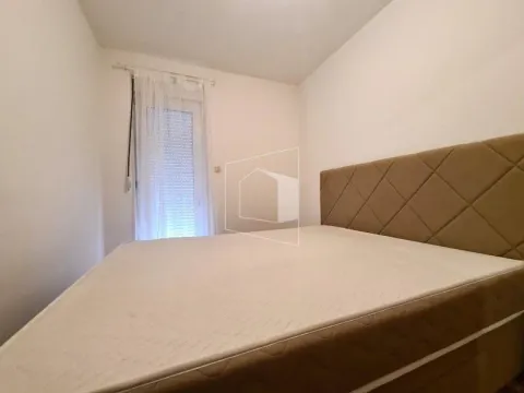 Small bedroom with a double bed and a window with a white curtain. - image 11