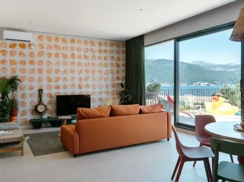 Spacious living room with sofa and sea view. - image 2