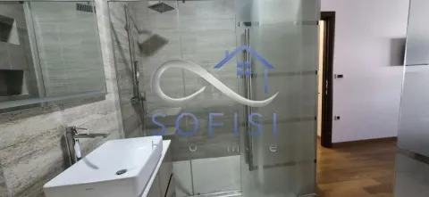 Modern bathroom with a washbasin and a shower cabin. - image 4