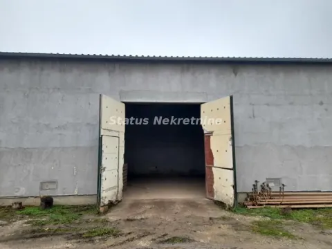 Exterior view of a warehouse or industrial building with large double doors. - image 10