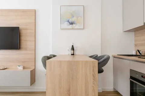 Living room with a dining table and built-in units. - image 7