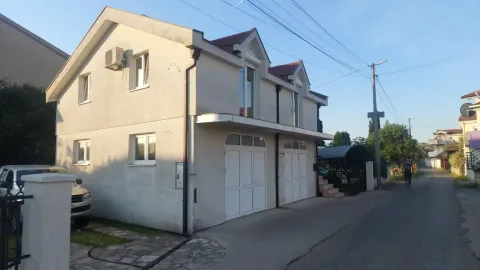 Exterior view of a two-story house with a garage and yard. - image 5