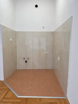 Part of a kitchen with wall tiles and water connections. - image 2