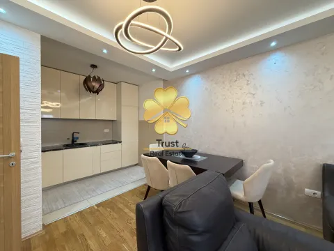 Living room with dining area and kitchen in a modern apartment. - image 4