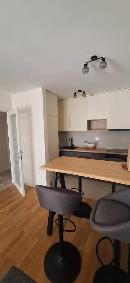 Modern kitchen with a breakfast bar and dining table.