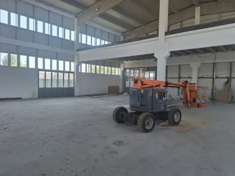 Large industrial space under construction with a lift machine. - image 2