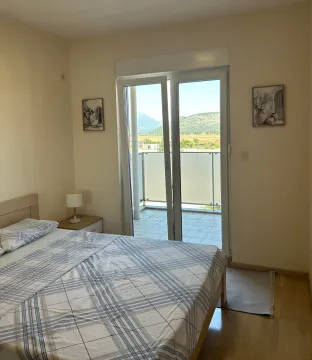 Bedroom with a double bed and access to the terrace. - image 7