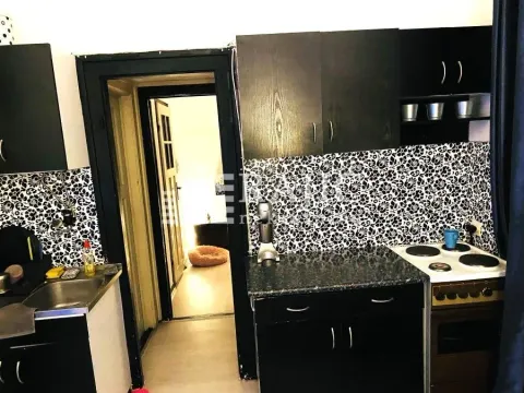 Small kitchen with black cabinets and patterned backsplash. - image 5
