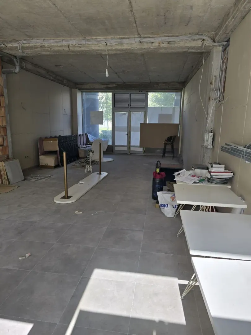 Unfinished commercial space in shell condition with tiled floor.
