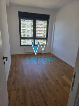 Empty room with wooden flooring and a window. - image 8