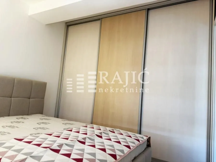 Bedroom with a bed and a large built-in wardrobe.