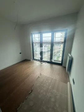 Empty unfinished room with wooden flooring and balcony doors. - image 4
