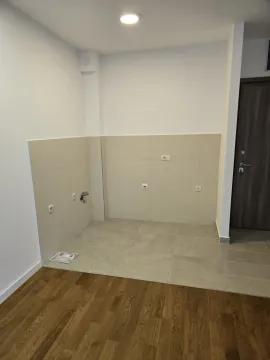 Empty kitchen area with tiled walls. - image 7