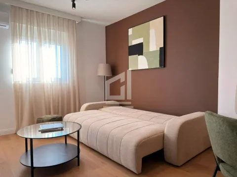 Living room with a beige sofa, coffee table, and window with curtains. - image 7