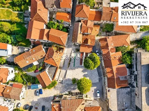 Aerial view of the historic town square and surrounding houses with red roofs. - image 2