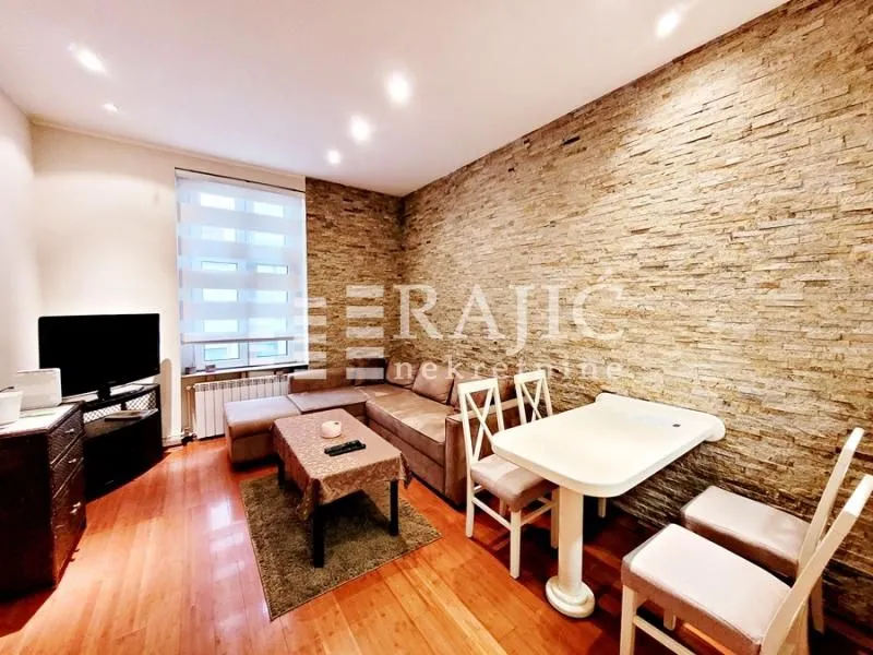 Living room with sofa and dining table.