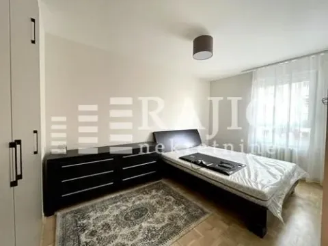 Furnished bedroom with a bed and wardrobe. - image 13