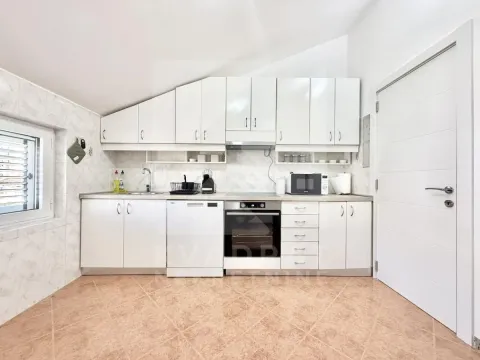 White kitchen with cabinetry and built-in appliances in the attic. - image 4