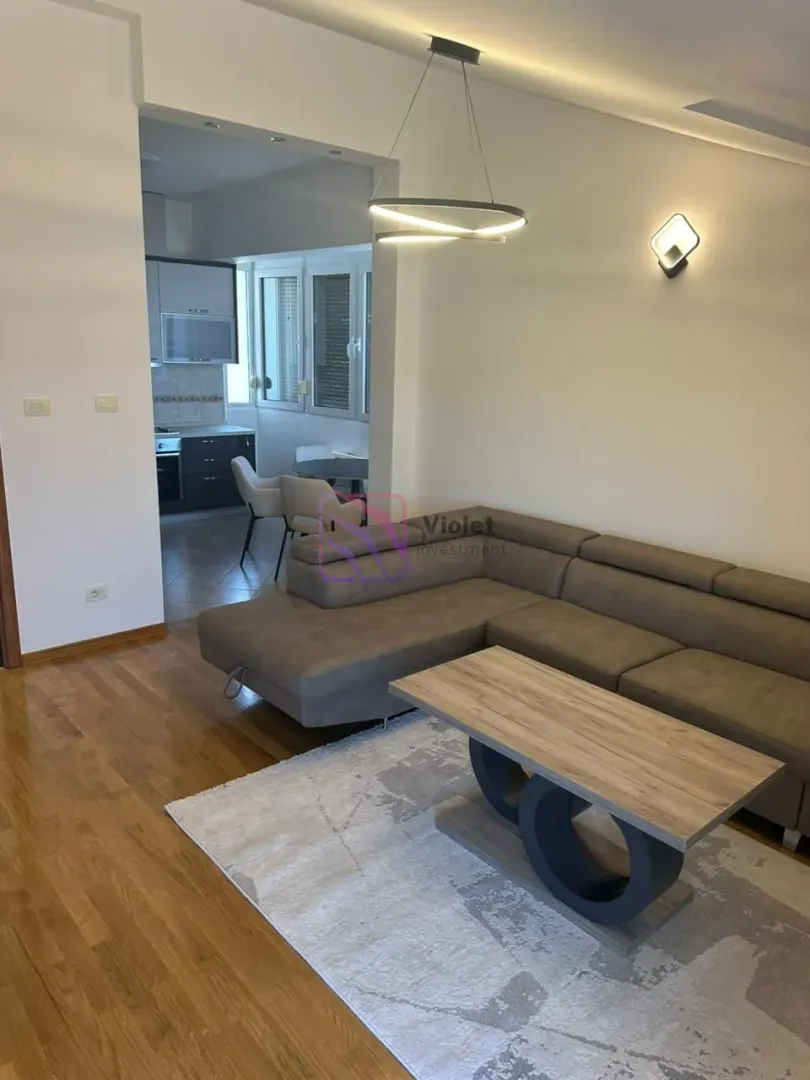 Living room with a sectional sofa and a view of the kitchen.
