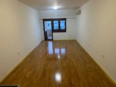 Empty room with parquet flooring and balcony access. - image 13