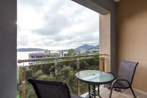 Covered balcony with outdoor seating and a sea view. - image 10