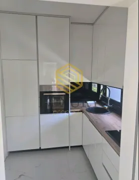Modern white kitchen with built-in appliances and wooden countertops. - image 3