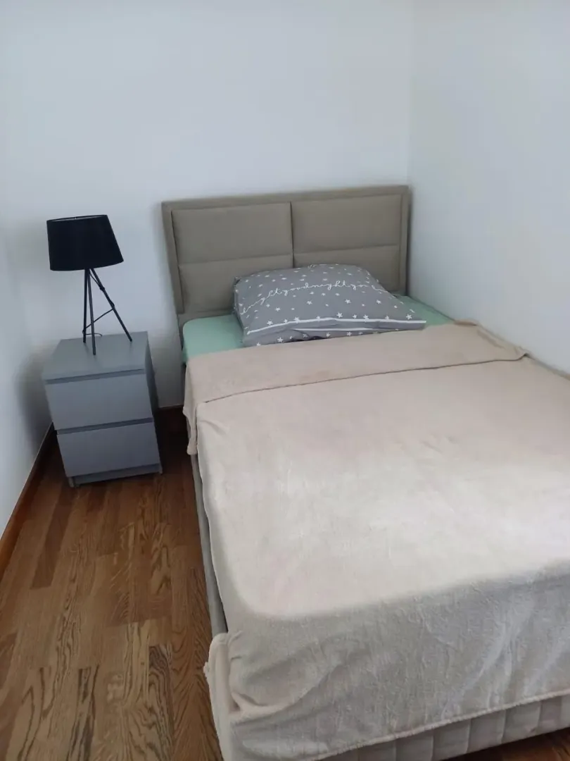 Small bedroom with a double bed and a nightstand.
