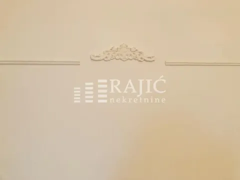 Wall detail with decorative molding and an agency watermark. - image 10