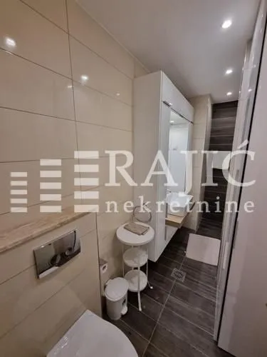 Modern bathroom with sanitary ware and built-in units.