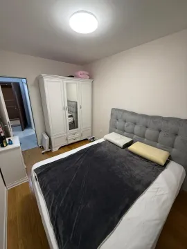 Furnished bedroom with a double bed and a wardrobe. - image 4