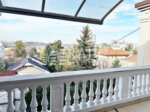 View of the city neighborhood from a spacious balcony with a white balustrade. - image 15