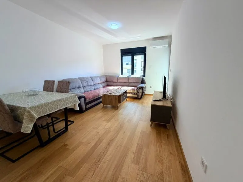 Spacious living room with a sofa set and a dining table.