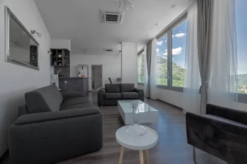 Living room with a sofa set and large windows offering a view. - image 2