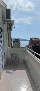 Balcony with a sea view and a chair. - image 5