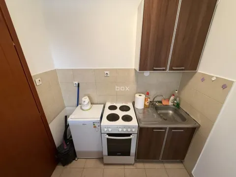 Small kitchen with a sink, electric stove, and refrigerator. - image 5
