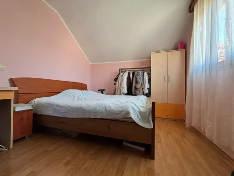 Bedroom with a double bed, wardrobe, and sloping ceiling. - image 11
