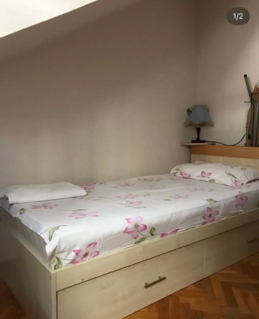 Smaller bedroom with a single bed and a nightstand.