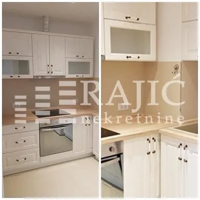 View of a white kitchen with a wooden countertop.