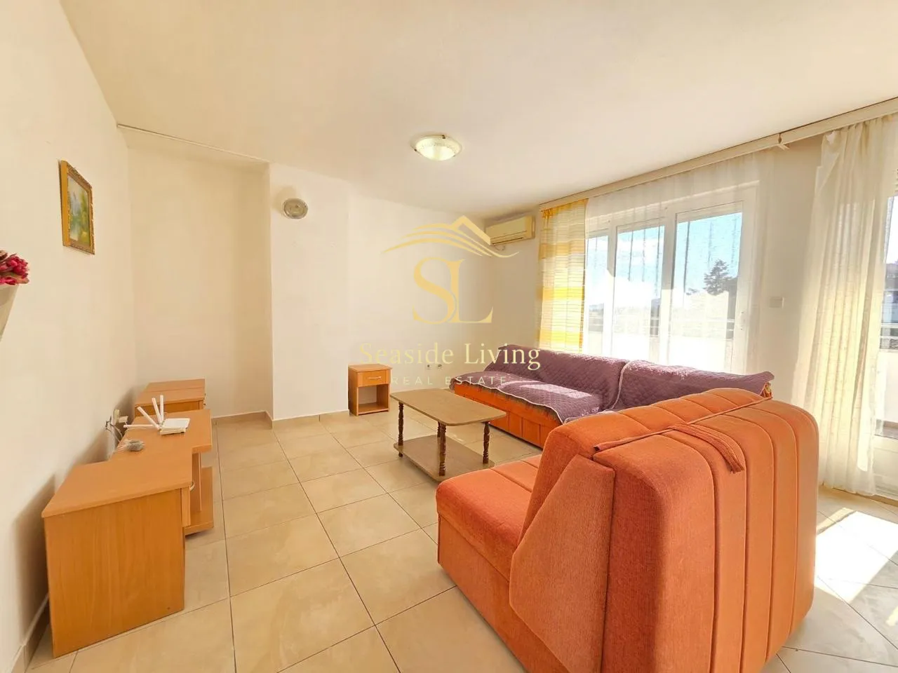 Living room with furniture and terrace access.