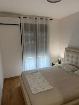 Bedroom with a double bed, nightstand, and air conditioning unit. - image 7