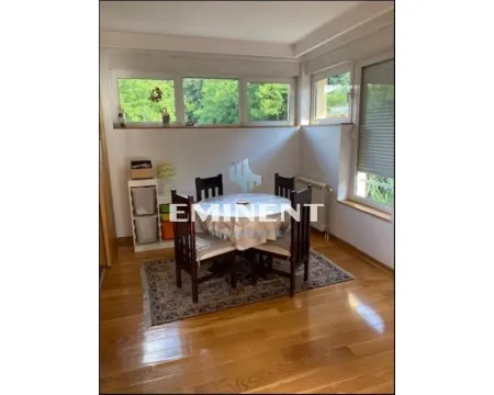 Dining area with a table, chairs, and wooden flooring. - image 3