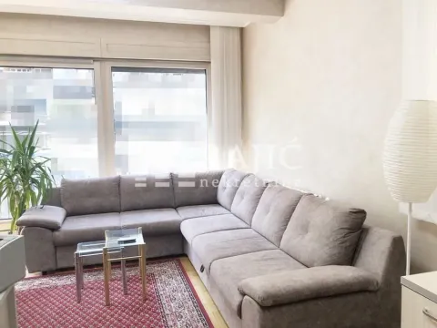 Living room with a sectional sofa and large windows. - image 15